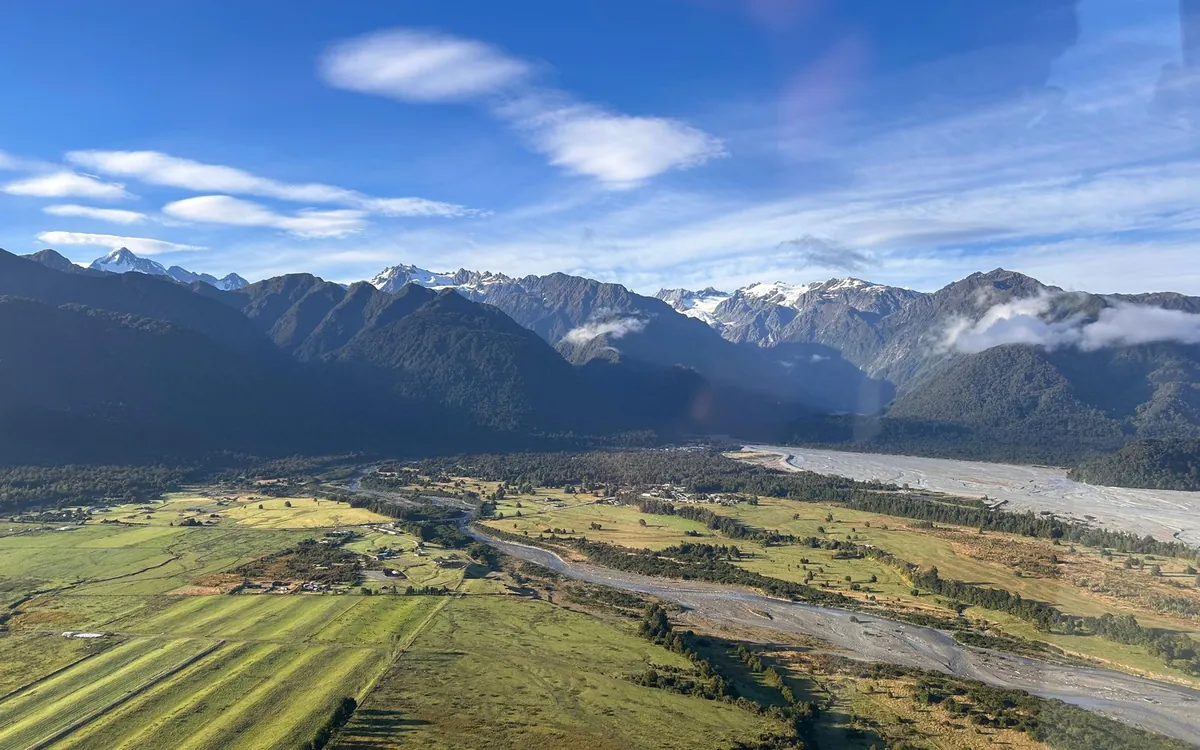 The braided riverbed and green valley below Franz Josef Glacier