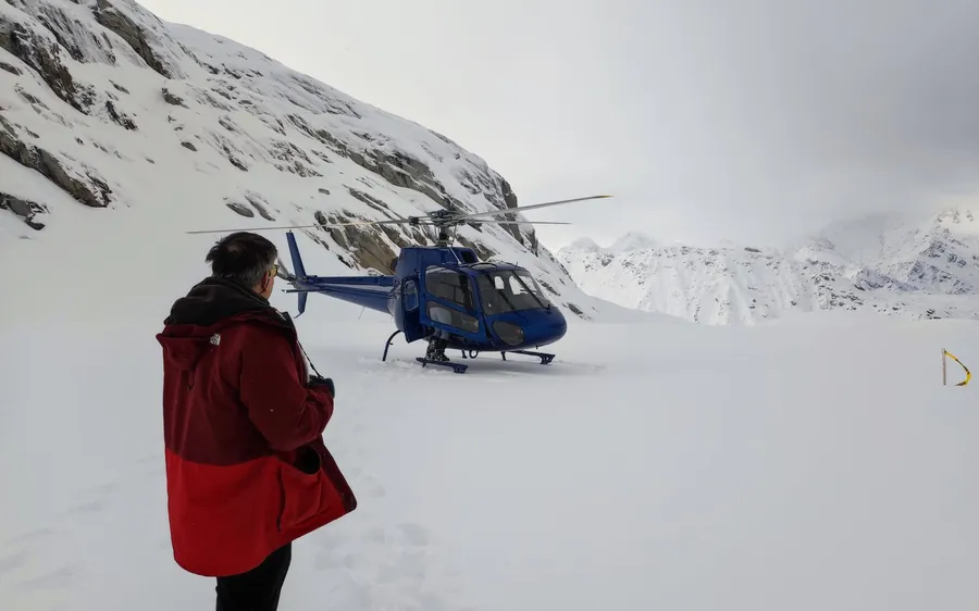Walkers on the ice below a helicopter on Franz Josef Glacier